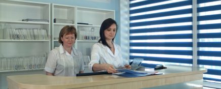 Smiling female doctors standing at the reception desk in hospital. Professional shot in 4K resolution. 097. You can use it e.g. in your commercial video, business, medicine, healthcare, technology, presentation, broadcast video.