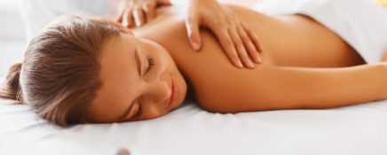Spa woman. Female enjoying relaxing back massage in cosmetology spa centre. Body care, skin care, wellness, wellbeing, beauty treatment concept.